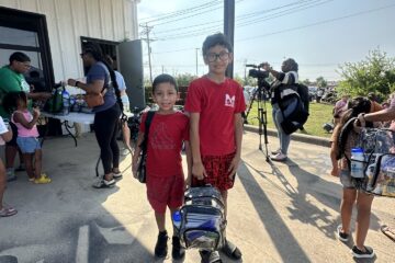 Waco area students with new backpacks from The Carlson Law Firm.